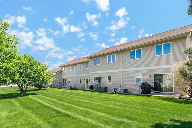 back of house with a yard and cooling unit