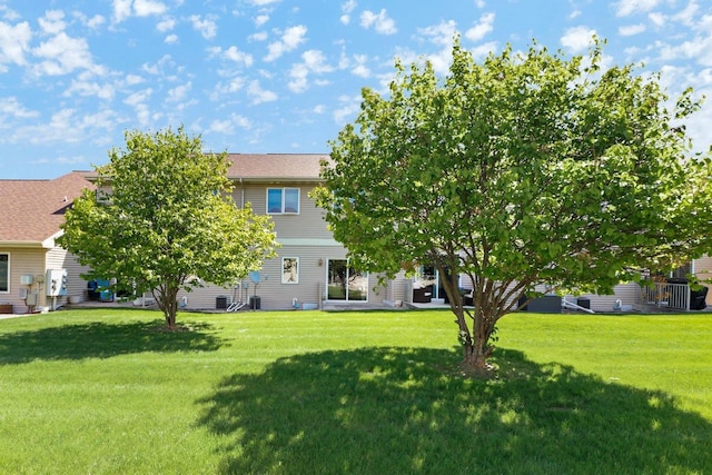 rear view of property featuring a lawn