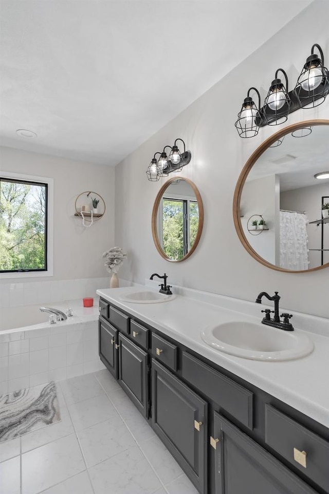3927 Southwyck Ct, Janesville, WI 53546 - bathroom featuring healthy amount of natural light, double vanity, tile patterned floors, and a garden tub