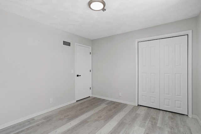 3927 Southwyck Ct, Janesville, WI 53546 - unfurnished bedroom featuring light wood-style floors, baseboards, and a closet