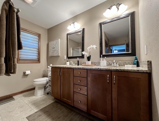 3960 Scenic Way Unit 4, Franksville, WI 53126 - bathroom with toilet, tile patterned flooring, baseboards, double vanity, and a textured wall