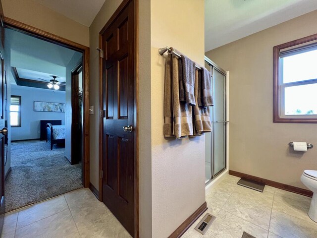 3960 Scenic Way Unit 4, Franksville, WI 53126 - ensuite bathroom with a shower stall, baseboards, tile patterned flooring, toilet, and a ceiling fan