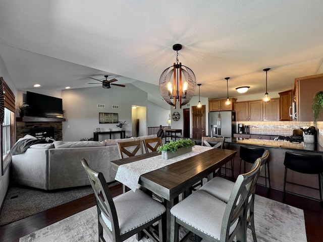 3960 Scenic Way Unit 4, Franksville, WI 53126 - dining room featuring a ceiling fan, wood finished floors, a chandelier, a stone fireplace, and recessed lighting