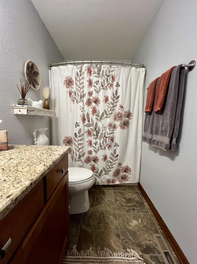 3960 Scenic Way Unit 4, Franksville, WI 53126 - full bath with vanity, toilet, stone finish floors, a shower with curtain, and baseboards