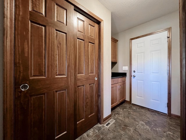 3960 Scenic Way Unit 4, Franksville, WI 53126 - doorway to outside with baseboards and a textured ceiling