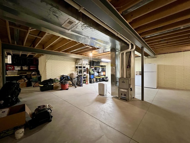 3960 Scenic Way Unit 4, Franksville, WI 53126 - unfinished below grade area featuring freestanding refrigerator and heating unit