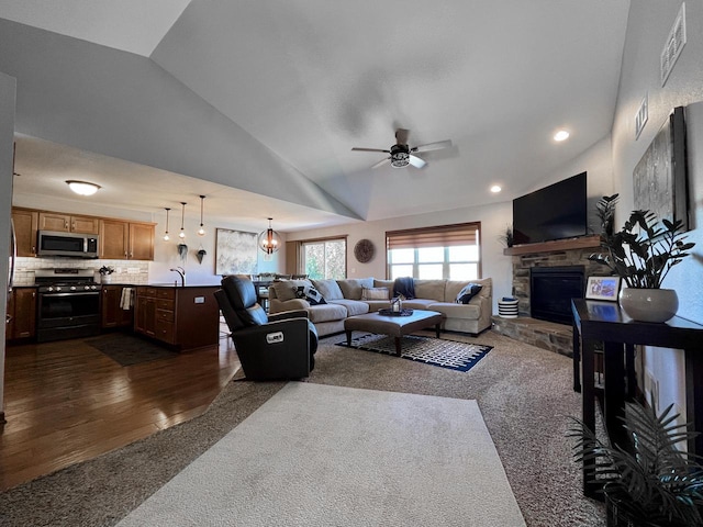 3960 Scenic Way Unit 4, Franksville, WI 53126 - living area featuring a fireplace, vaulted ceiling, a ceiling fan, dark carpet, and recessed lighting