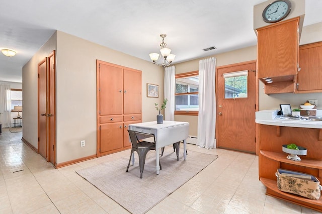dining space with a chandelier and baseboard heating