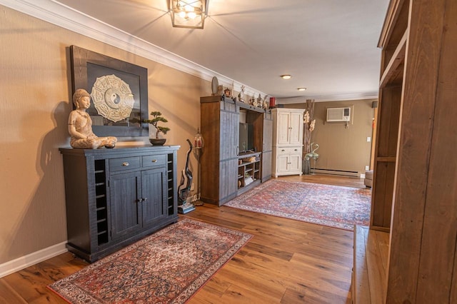 1212 Grand Ave Unit # 30, Wausau, WI 54403 - hallway featuring crown molding, baseboard heating, a wall unit AC, wood finished floors, and baseboards