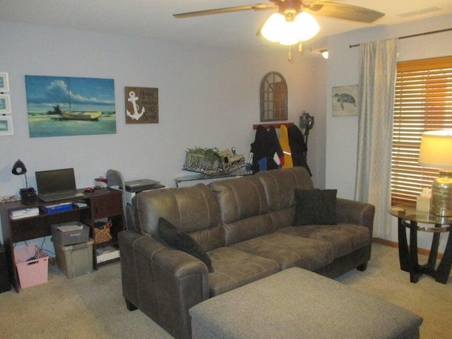 carpeted living room with ceiling fan