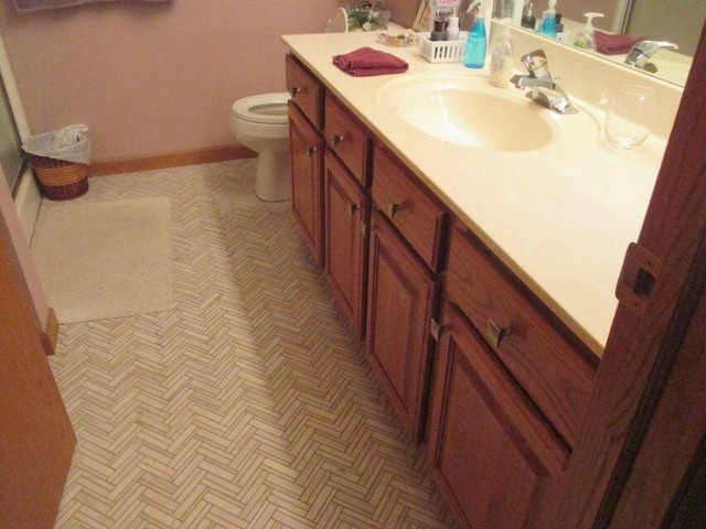 bathroom featuring toilet and vanity