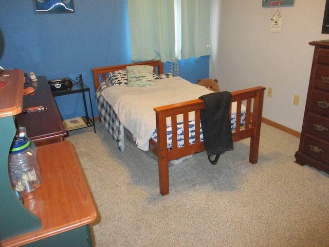 carpeted bedroom featuring baseboards