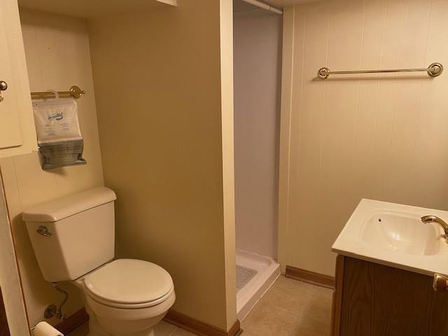 301 E Coldspring Ave, Madison, WI 53716 - bathroom featuring a stall shower, toilet, vanity, baseboards, and tile patterned flooring