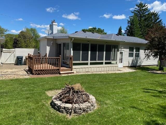 301 E Coldspring Ave, Madison, WI 53716 - rear view of property featuring a sunroom, a chimney, a wooden deck, a fire pit, and a gate
