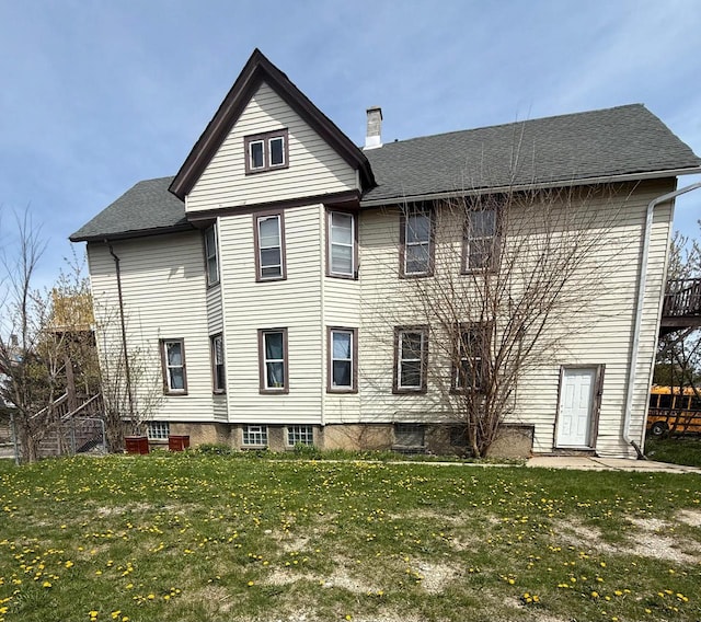 3332 N Richards St, Milwaukee, WI 53212 - back of house with a chimney, a lawn, and a shingled roof