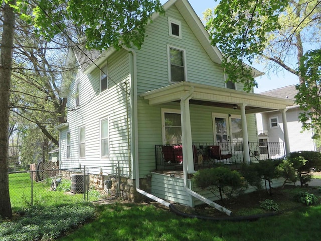 944 9th St, Beloit, WI 53511 - view of front of property with a porch, cooling unit, and fence