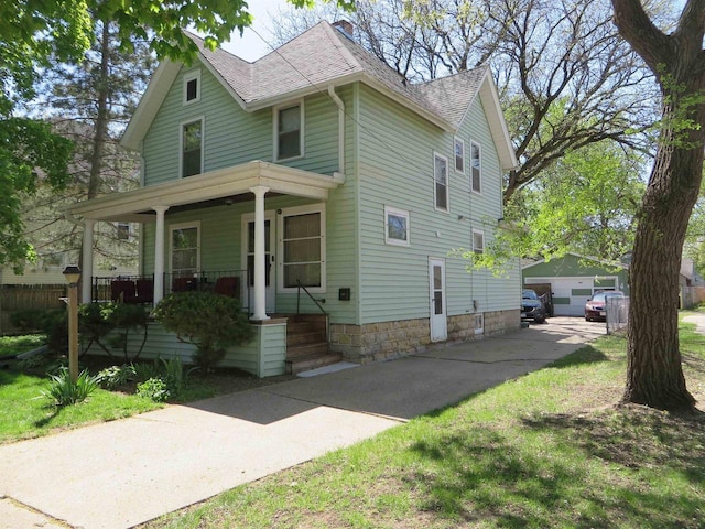 944 9th St, Beloit, WI 53511 - view of front of house with a porch, roof with shingles, a detached garage, and an outdoor structure