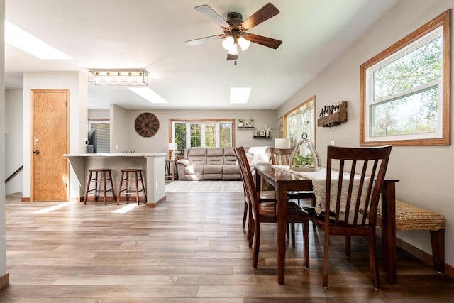 7929 N Pine View Dr, Edgerton, WI 53534 - dining room featuring a skylight, wood finished floors, and a ceiling fan