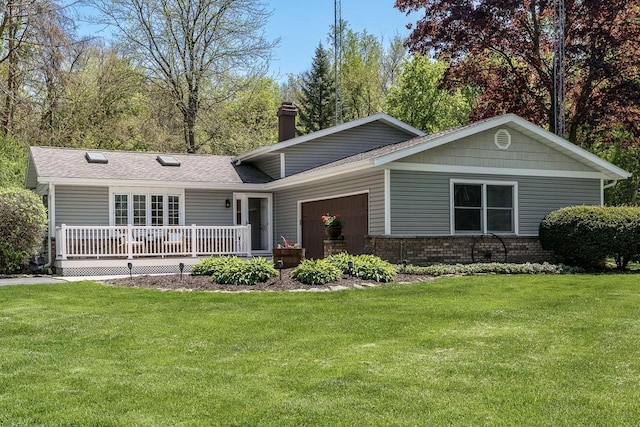 7929 N Pine View Dr, Edgerton, WI 53534 - view of front of property with a front lawn, a chimney, a garage, and brick siding