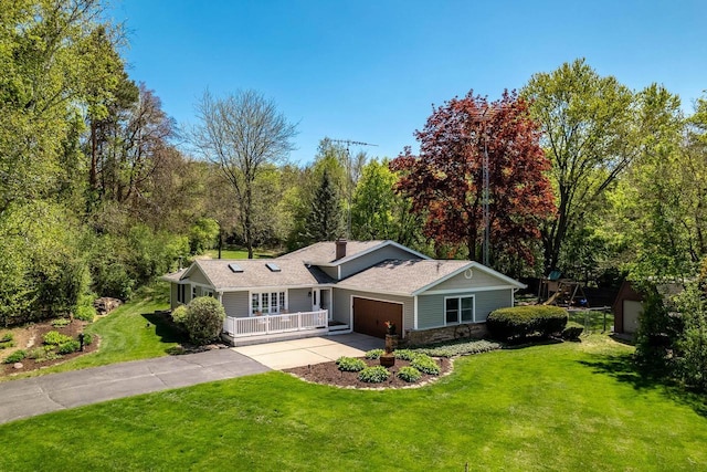 7929 N Pine View Dr, Edgerton, WI 53534 - ranch-style home with driveway, a front yard, an attached garage, stone siding, and a forest view