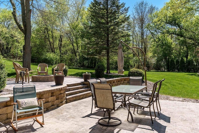 7929 N Pine View Dr, Edgerton, WI 53534 - view of patio featuring outdoor dining space and a fire pit