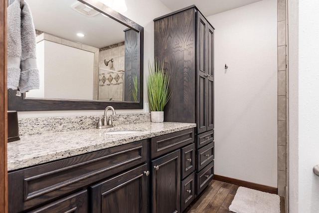 7929 N Pine View Dr, Edgerton, WI 53534 - bathroom with wood finished floors, vanity, baseboards, and tiled shower