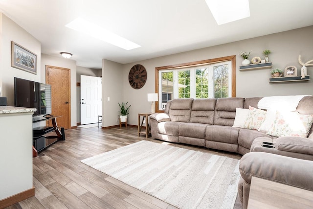 7929 N Pine View Dr, Edgerton, WI 53534 - living area featuring a skylight, wood finished floors, and baseboards