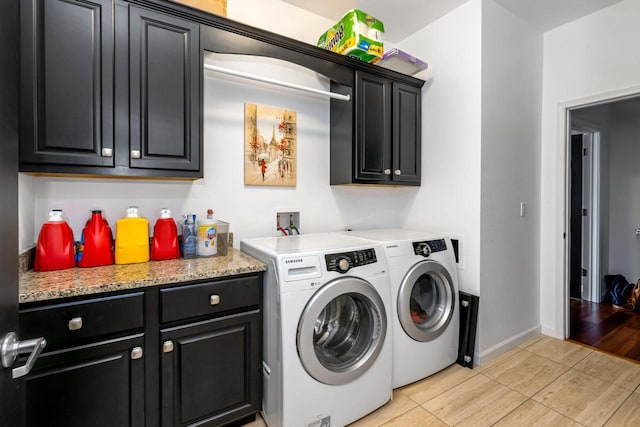 601 E Ogden Ave Unit 803, Milwaukee, WI 53202 - clothes washing area featuring washer and clothes dryer, cabinet space, light tile patterned floors, and baseboards