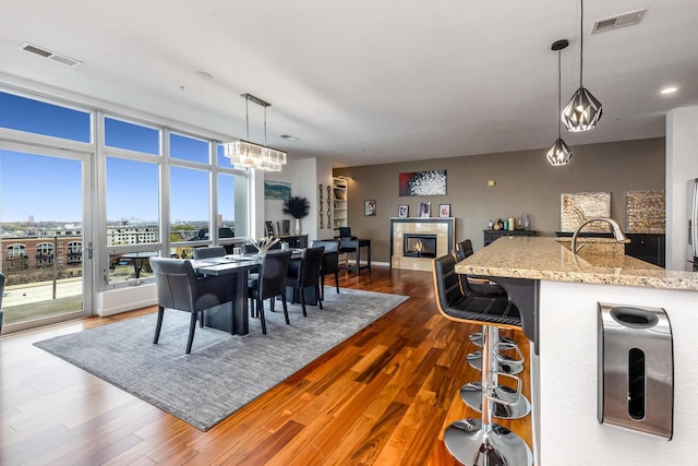 601 E Ogden Ave Unit 803, Milwaukee, WI 53202 - dining space featuring a fireplace, dark wood finished floors, a chandelier, and recessed lighting