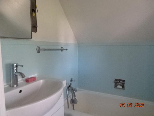 413 S Howard St, Princeton, WI 54968 - full bath featuring a sink, a tub, and lofted ceiling
