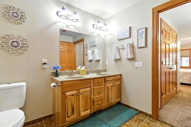 1822-3 Parkland Dr Unit 0703, Arkdale, WI 54613 - ensuite bathroom featuring baseboards, toilet, tile patterned floors, and double vanity