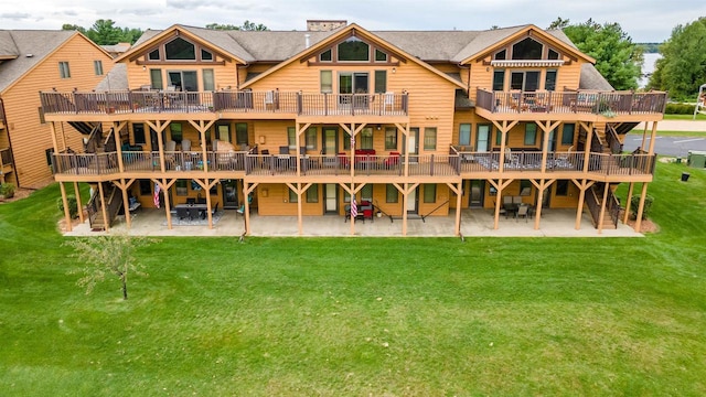 1822-3 Parkland Dr Unit 0703, Arkdale, WI 54613 - rear view of house featuring a lawn, a patio, and a deck