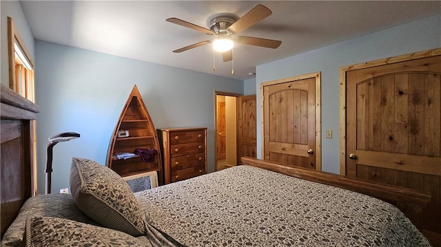 9138 W Johnson Rd, Hayward, WI 54843 - bedroom with a ceiling fan and a fireplace