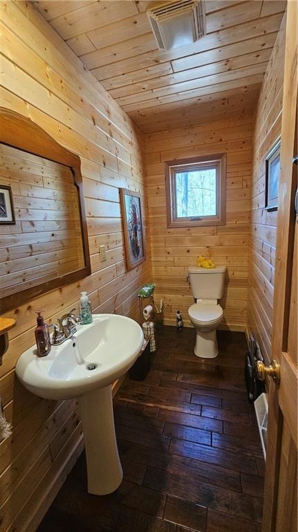 9138 W Johnson Rd, Hayward, WI 54843 - bathroom with wooden ceiling, toilet, hardwood / wood-style flooring, and wood walls