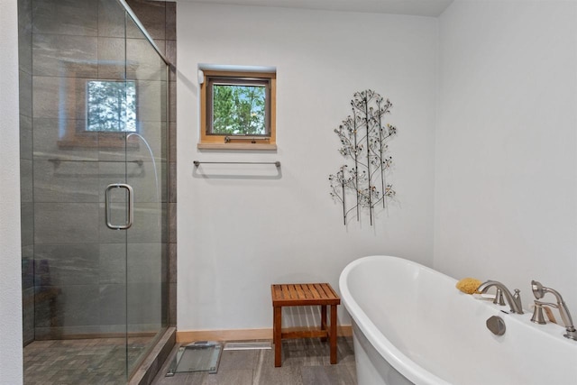 2191 County Road G, Nekoosa, WI 54457 - bathroom featuring a shower stall, a soaking tub, and baseboards