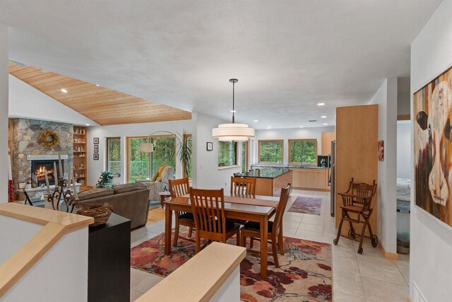 2191 County Road G, Nekoosa, WI 54457 - dining room with a stone fireplace, light tile patterned floors, recessed lighting, built in shelves, and baseboards