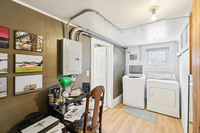 604 9th Ave, Baraboo, WI 53913 - washroom with electric panel, washer and clothes dryer, and light wood-style flooring