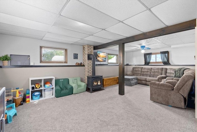 E7065 County Road B, Colfax, WI 54730 - living room featuring a wood stove, carpet, and a drop ceiling
