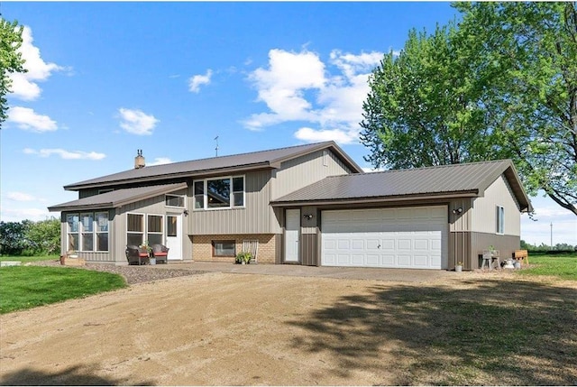 E7065 County Road B, Colfax, WI 54730 - view of front of house with driveway, a garage, brick siding, and a chimney