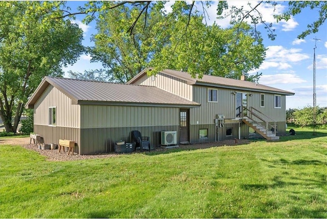 E7065 County Road B, Colfax, WI 54730 - back of house featuring a lawn, ac unit, and metal roof