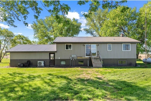 E7065 County Road B, Colfax, WI 54730 - rear view of property with a cooling unit, a lawn, metal roof, and board and batten siding