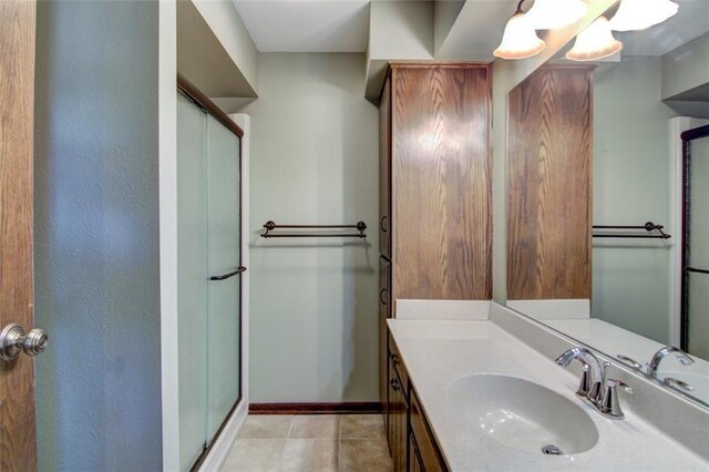 1206 Nixon Ave, Eau Claire, WI 54701 - full bath with a shower stall, vanity, baseboards, and tile patterned flooring