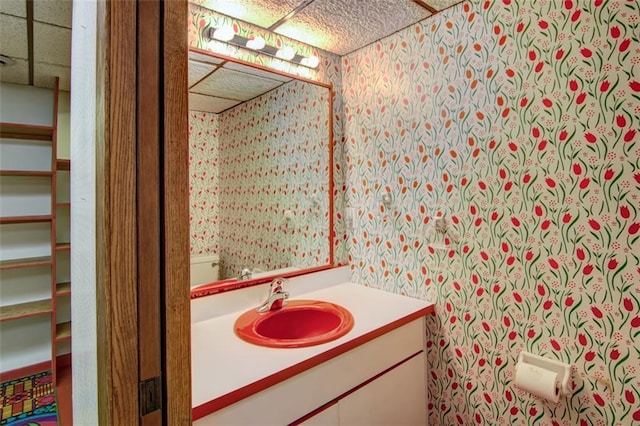 1206 Nixon Ave, Eau Claire, WI 54701 - half bath with wallpapered walls, a paneled ceiling, and vanity