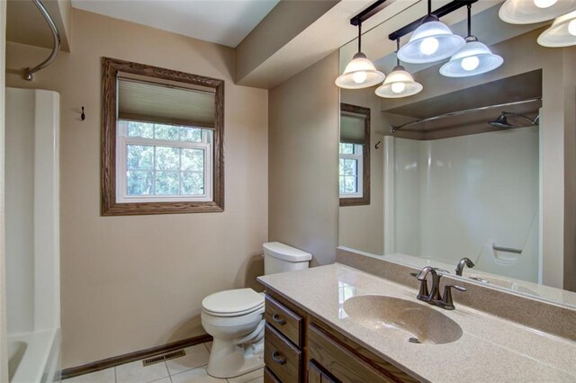 1206 Nixon Ave, Eau Claire, WI 54701 - bathroom featuring healthy amount of natural light, toilet, tile patterned floors, and baseboards