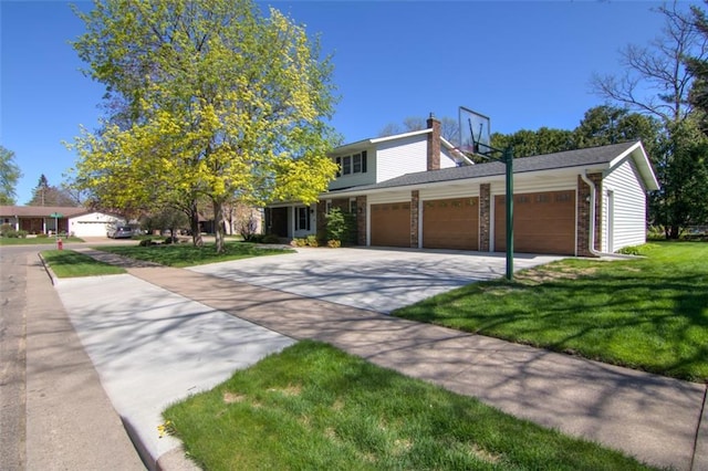 1206 Nixon Ave, Eau Claire, WI 54701 - traditional home featuring an attached garage, driveway, a chimney, a front lawn, and brick siding