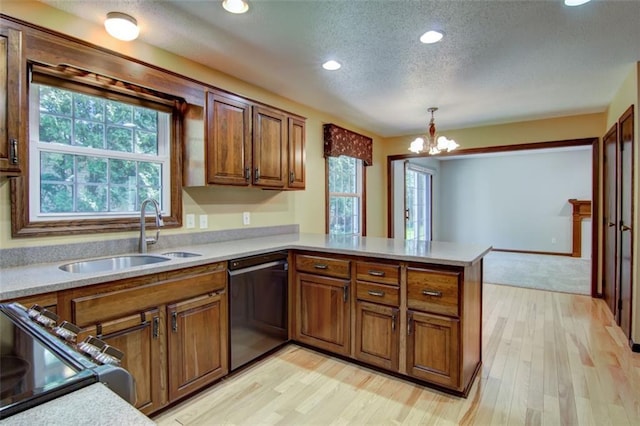 1206 Nixon Ave, Eau Claire, WI 54701 - kitchen with dishwasher, a sink, a peninsula, a textured ceiling, and plenty of natural light