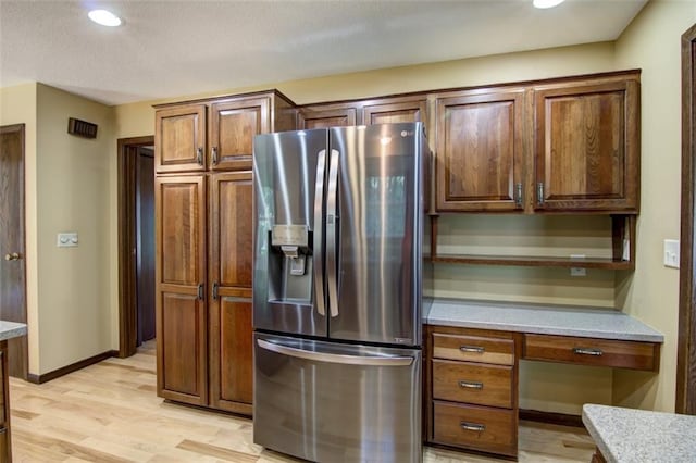 1206 Nixon Ave, Eau Claire, WI 54701 - kitchen with stainless steel fridge, light wood-style flooring, open shelves, recessed lighting, and baseboards