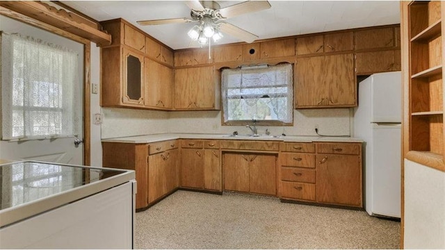 41 E Euclid Ave, Barron, WI 54812 - kitchen featuring white appliances, a sink, light countertops, and brown cabinetry
