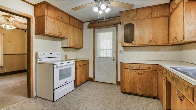 41 E Euclid Ave, Barron, WI 54812 - kitchen with white electric stove, a ceiling fan, light countertops, and brown cabinetry