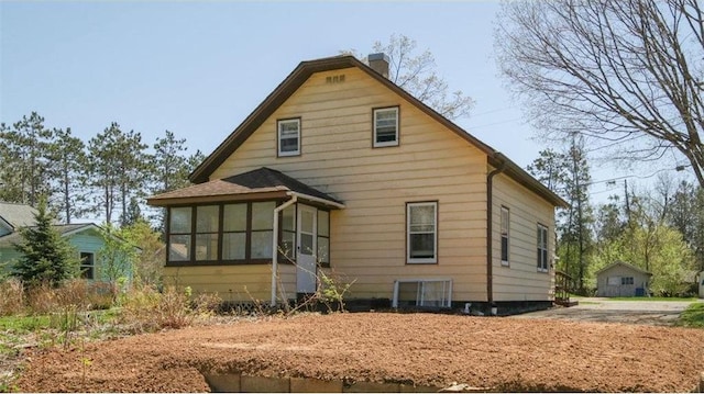 41 E Euclid Ave, Barron, WI 54812 - rear view of property featuring a chimney and a sunroom